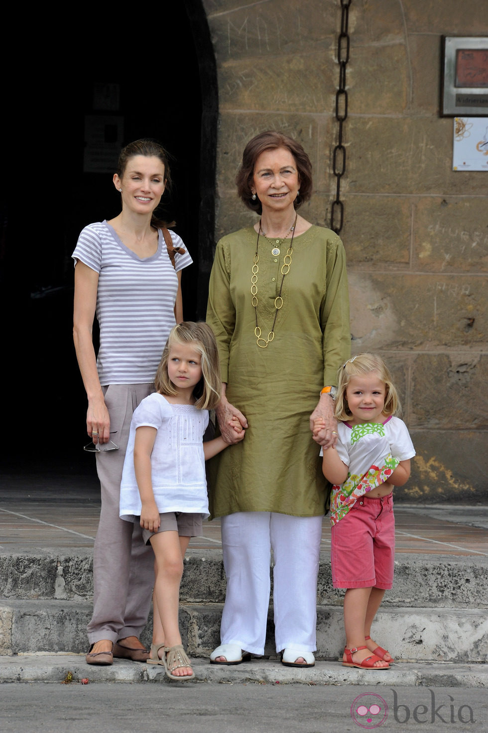 Look de la reina Sofía con kaftan verde oliva y pantalón blanco en verano de 2010