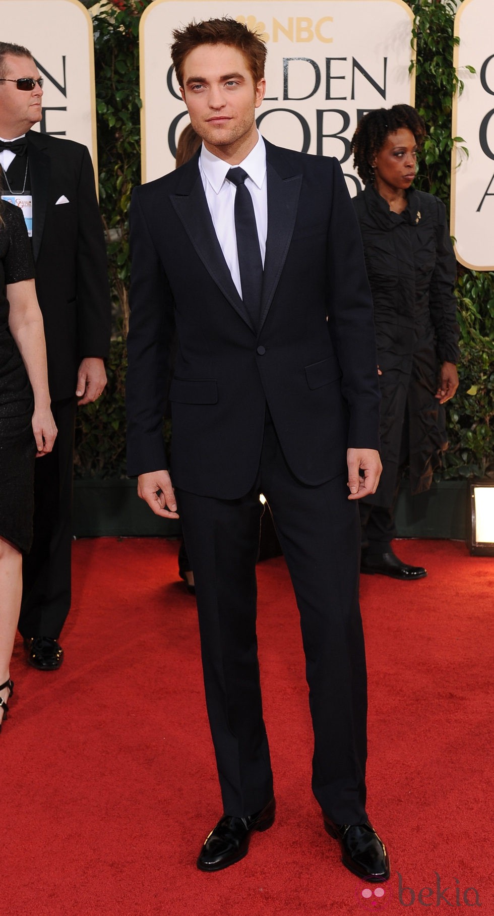 Robert Pattinson con un traje negro con corbata negra y camisa blanca