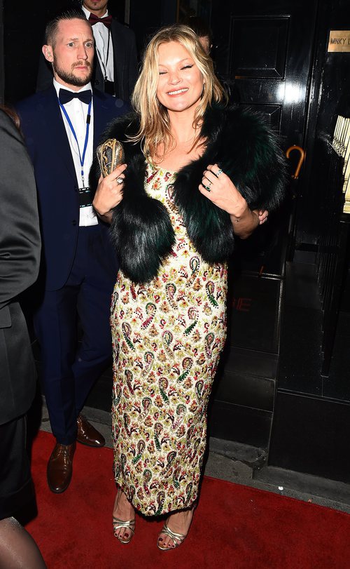 Kate Moss con un vestido de pedreria en tonos burdeos y verdes en Londres 2018