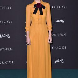 Dakota Johnson con vestido retro en color mostaza